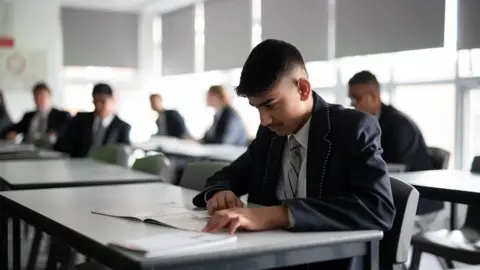 Getty Images Year 10 pupils attend an English lesson at Moor End Academy in Huddersfield, northern England on September 11, 2020.