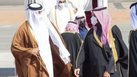 Qatar's Emir Sheikh Tamim bin Hamad Al Thani is greeted by Saudi Crown Prince Mohammed bin Salman in al-Ula, Saudi Arabia