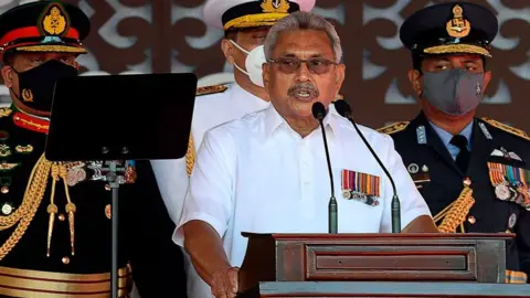 Getty Images Sri Lanka's President Gotabaya Rajapaksa (C) addresses the nation along with Army Commander Shavendra Silva (L), Navy Chief Nishantha Ulugetenne (2L) and Airforce Chief Sudarshana Pathirana (R) during the Sri Lanka's 73rd Independence Day celebrations in Colombo on February 4, 2021