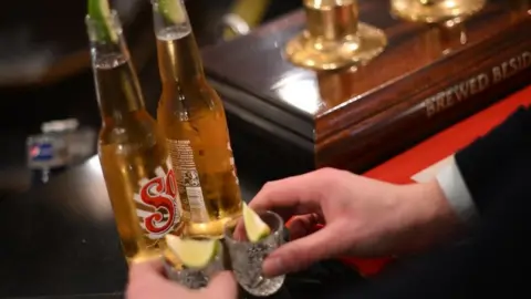 Getty Images Two people about to drink shots.