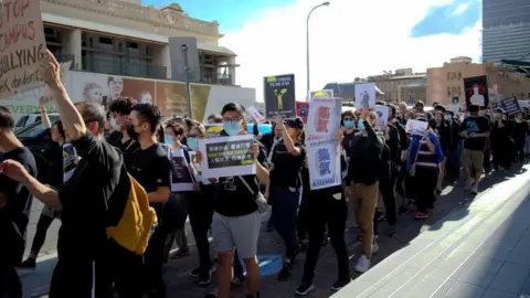 PHOEBE FAN Pro-democracy supporters protesting in Brisbane on 28 July