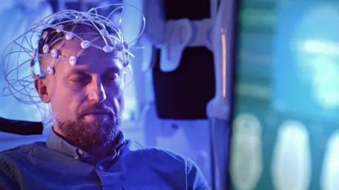 Getty Images A stock image of someone having an EEG in a lab