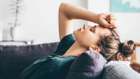 Getty Images Woman having a migraine