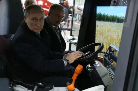 Getty Images Russian President Vladimir Putin (L) examines a tractor simulator while visiting a tractor plant of Rostselmash on February 1, 2018 in Rostov-on-Don, Russia.