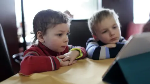 Getty Images Children looking at a tablet