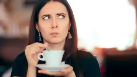 Getty Images Woman drinking a cup of tea