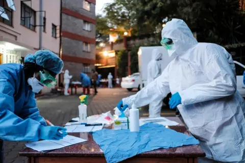 AFP Doctors prepare to administer the mandatory COVID-19 coronavirus test for detainees of a Government designated quarantine facility in Nairobi on March 29, 2020