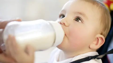 SPL Baby drinking. Nine month old boy drinking a bottle of milk. feeding a baby.