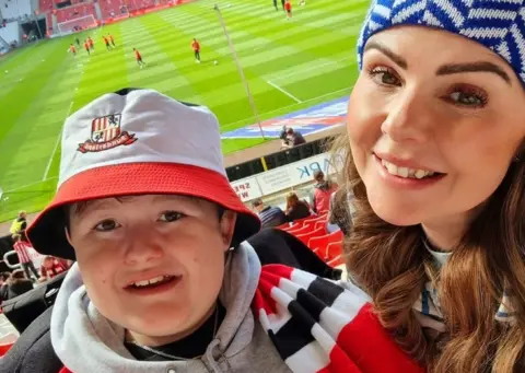 Family photograph Helen and her son Charlie at the match