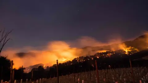 AFP Fire glows on a hillside in Napa, California on October 9, 2017, as multiple wind-driven fires continue to whip through the region.