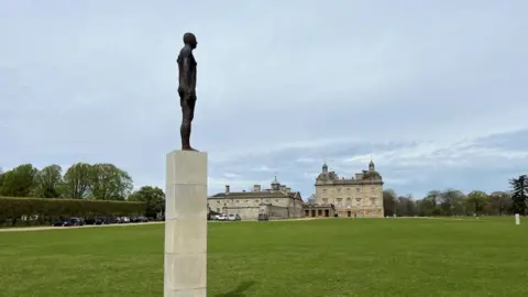 Shaun Whitmore/BBC An iron sculpture on a plinth at Houghton Hall.