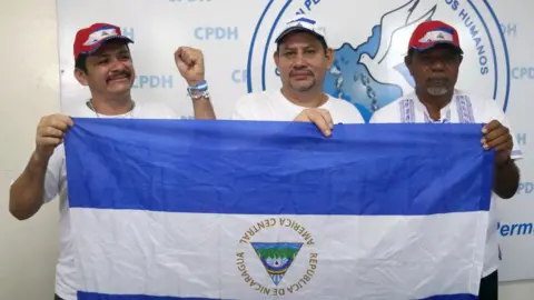 AFP farmers' Movement leaders Medardo Mairena, Pedro Mena and Freddy Navas celebrate after being released on 11 June, 2019 in Managua