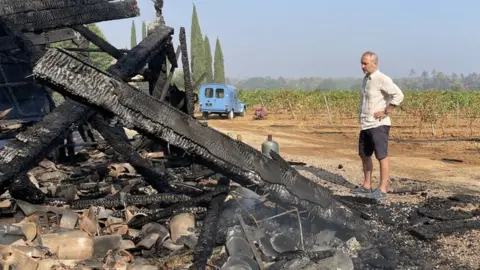 Stephen and Jeany Cronk Stephen Cronk in front of a burned barn at Domaine Mirabeau