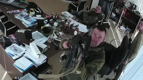 Russian soldiers shortly before they destroy a camera