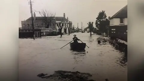 G. Cordy Collection - Felixstowe Museum A man rows a boat in Felixstowe during the 1953 floods