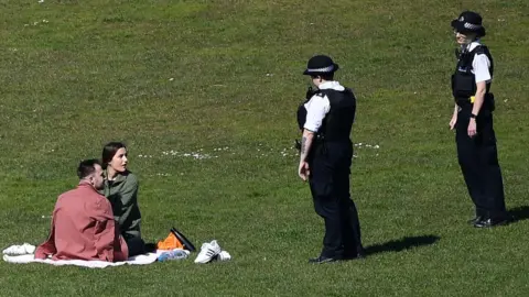 Getty Images Police speak to couple in London park