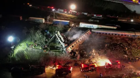 Reuters Rescue workers around train