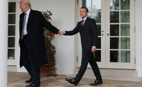 AFP French President Emmanuel Macron (R) and US President Donald Trump (R) walk hand in hand at the White House, 24 Apr 2018