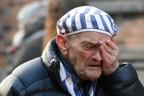 Reuters A survivor reacts at a Holocaust wreath-laying ceremony