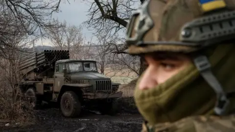 Reuters File image of a Ukrainian solider and a military vehicle in a wintry scene