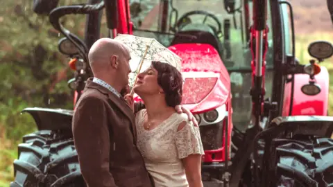 Bill Baillie Robert Connelly and Annalisa Falanga wedding pic in front of tractor