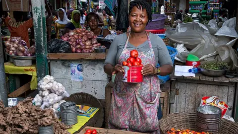 Getty Images A vegetable trader at Circle market in Accra, Ghana - August 2015