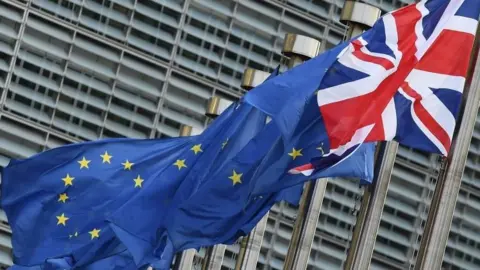 AFP/Getty Images A British flag flies next to EU flags in Brussels. File photo