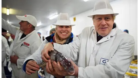 PA Media Boris Johnson at a fish market in Grimsby