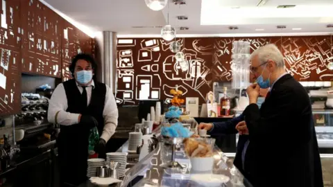 Reuters A man at a cafe in Italy