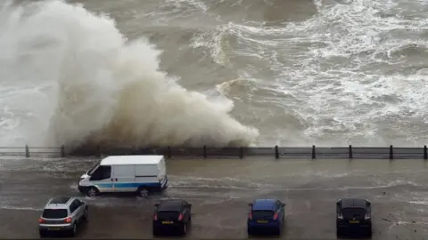 AFP Waves crash over the wall at Newhaven Harbour, East Sussex