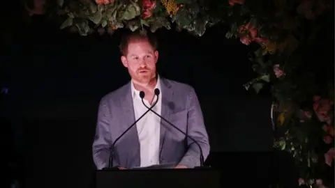 Getty Images Prince Harry speaking on Sunday evening