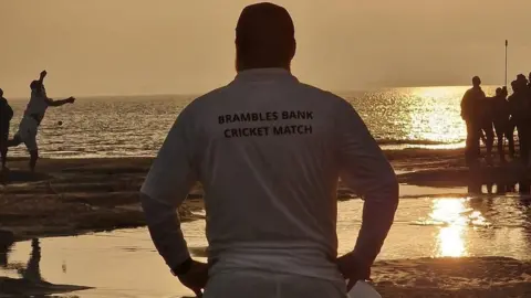 Emma Pain – Island Sailing Club Brambles sandbar cricket match at sunrise