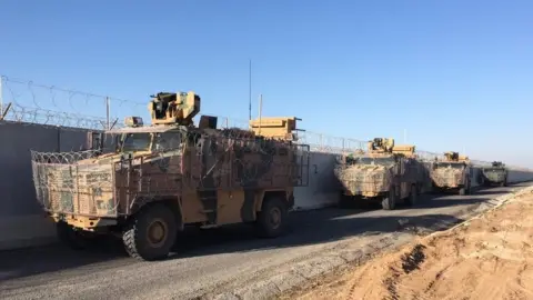 Getty Images/TURKISH DEFENSE MINISTRY  Turkish and Russian troops are seen after they completed the eighth round of joint ground patrols in northern Syria. 18 Nov 2019