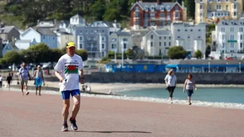 Reuters Exercising on the beach at Llandudno