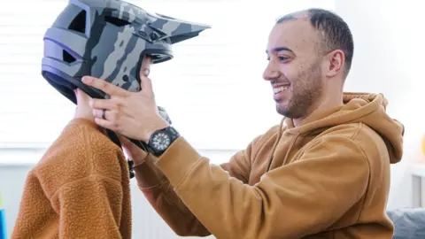 Dimitris Legakis/Athena Pictures Louis Gray and his son