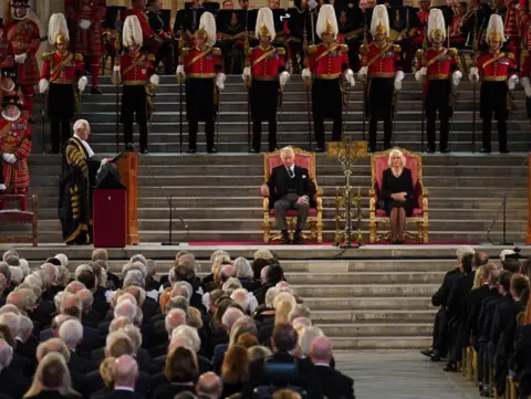 Stefan Rousseau/PA  King Charles III and the Queen Consort listen to Speaker of the House of Lords Lord McFall of Alcluith