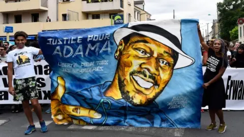 Getty Images Protesters with a Justice for Adama banner