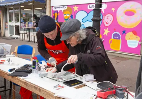 BBC Volunteers repair electrical items at the Fixing Factory in Camden, London