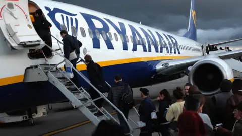 Getty Images Passengers boarding Ryanair plane