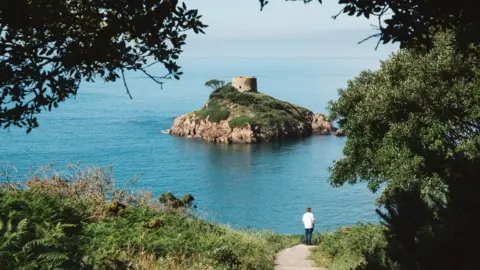 National Trust for Jersey A walker admiring Portelelt