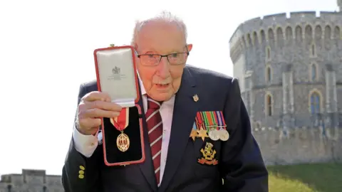 Reuters Captain Tom receives knighthood from Britain"s Queen Elizabeth at Windsor Castle