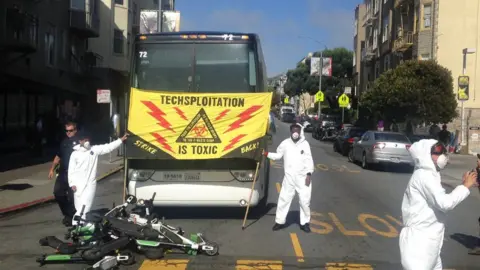 Twitter/ @allekto  Protesters stacked electric scooters in the buses path