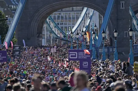 Jonathan Brady/PA Media London Marathon runners at Tower Bridge