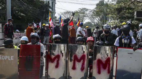 EPA Demonstrators carried shields as they prepared for clashes with Myanmar armed forces during a protest against the military coup in Mandalay, Myanmar, 07 March 2021