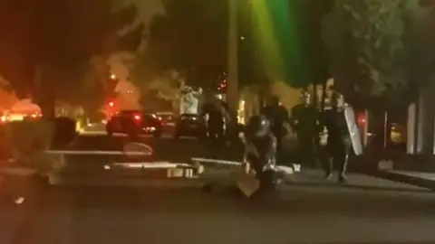 Twitter Video posted on social media purportedly showing riot police beating a woman in Iran