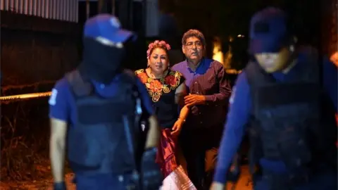 Reuters People react next to police officers guarding a crime scene where unidentified assailants opened fire at a bar in Minatitlan, in Veracruz state, Mexico, April 19, 2019.