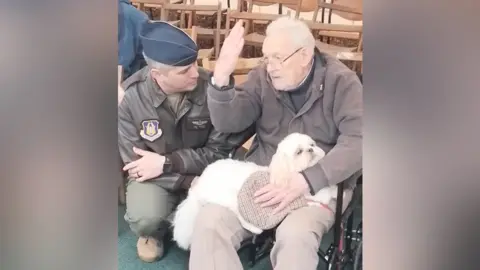 The Blagdon Local History Society Brian Durbin at the ceremony, sitting talking to a man in military uniform