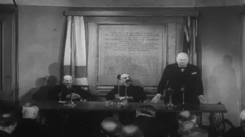 Wartime Prime Minister Winston Churchill (right) and his successor Clement Atlee (left) returned to Church House after the way to thank the organisation