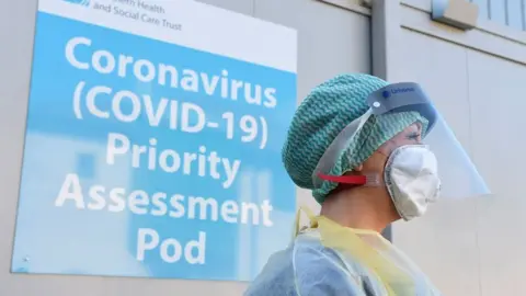 PA Media Health worker outside a Covid-19 assessment pod