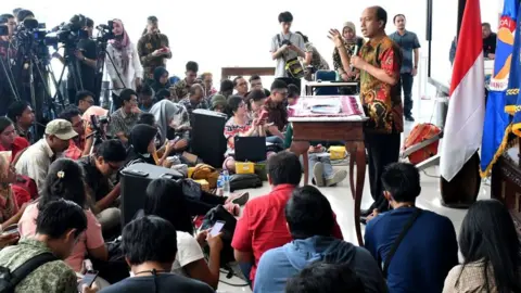 AFP/Getty Images Sutopo speaking to reporters